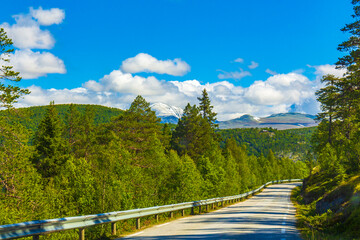 Mountain road through forests landscape and mountains in Kvitfjell Norway.