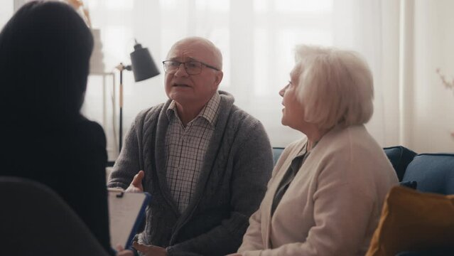 Senior woman complaining about husband during couple's therapy, risk of divorce