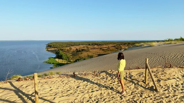 Congnitive pathway in Nagliai reserve in curonian spit. Female tourist in scenic curonian spit panoramic viewpoint in reserve surrounded. Lithuania famous travel destination