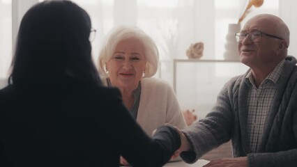 Happy senior people shaking hands with health insurance agent, agreement, deal
