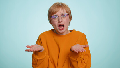 What Why. Sincere irritated woman in glasses raising hands in indignant expression, ask reason of...