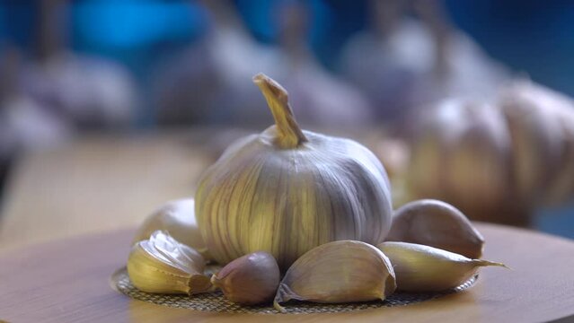 fresh garlic swirling on a wooden table