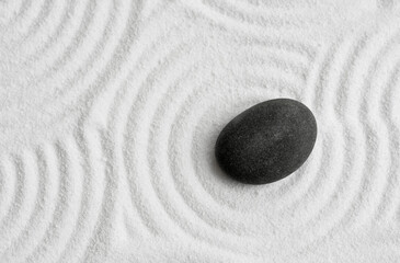 Zen Stone with White Sand Texture Background, Top View Zen Garden with Black Rock Sea Stone on Sand  Wave Parallel Lines Pattern in Japanese stye, Banner for Harmony,Meditation,Zen like concept