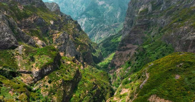 Pico do Areeiro, Madeira: Stunning aerial view of majestic mountain peak and mountain valley. Hikers, nomads, and sightseers embrace the captivating landscape.