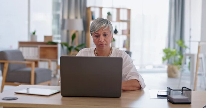 Laptop, typing and senior business woman, human resources or HR manager check employee files on company system. Research, office and elderly person working on KPI report, project or search online