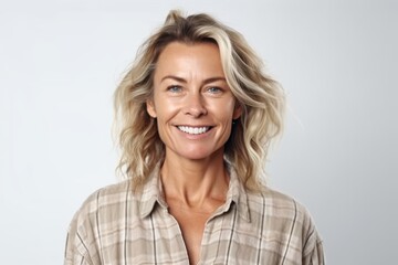 Portrait of beautiful middle aged woman smiling at camera over white background