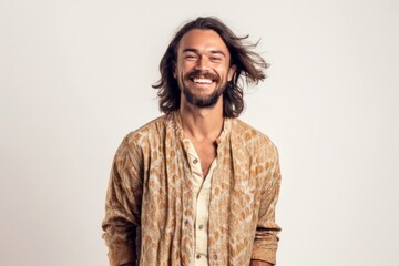 Portrait of a young man with long hair laughing on a white background