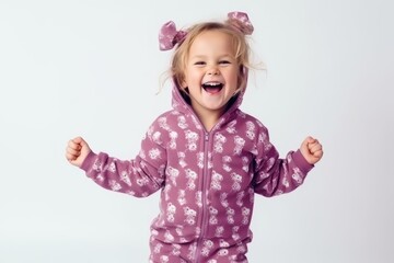 Happy little girl in warm clothes on a white background in the studio