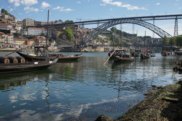 Fototapeta na wymiar Barges used to carry port on the River Douro and the Terreiro da Sé in the city of Porto, Portugal 