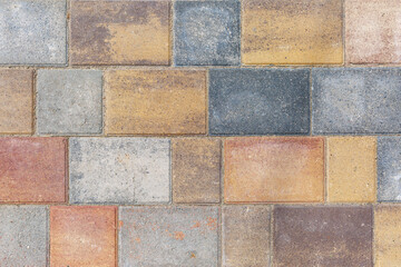 Paving slabs from multi-colored squares. Background. Space for text. Construction, repair and design.