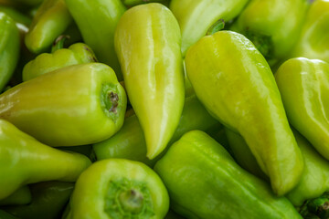 Lots of fresh green sweet peppers on the counter. Organic food, health and vitamins Close-up.