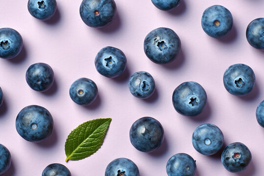 Top vie wof Blueberry fruits on violet background.