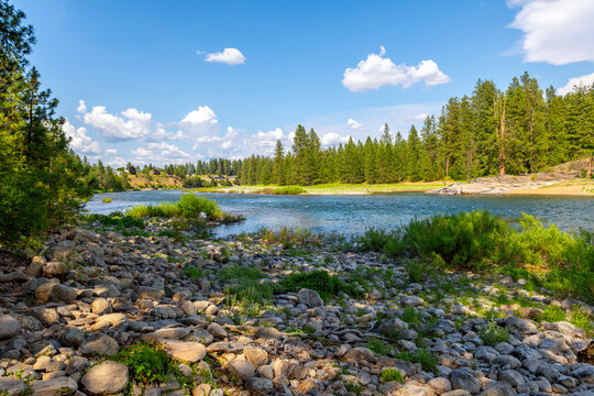 The rocky riverbank and shoreline of the Spokane River as it runs through the small town of Post Falls, Idaho, at McGuire Park.
.