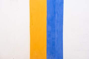 White wall with blue and yellow stripes