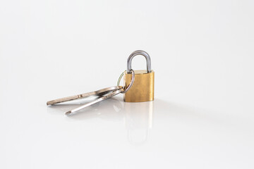 Gold locked padlock and keys on white background. Home security concept