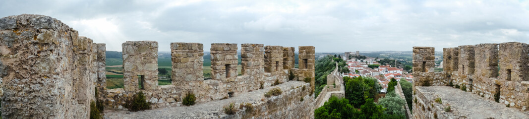 Fototapeta na wymiar Óbidos, the medieval muraled city on the west of Portugal. Panoramic view of an ancient castle of Europe.