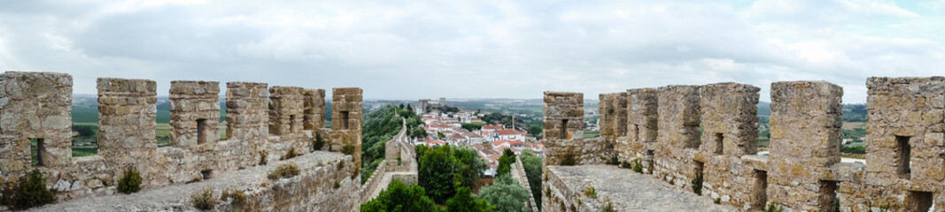 Fototapeta na wymiar Óbidos, the medieval muraled city on the west of Portugal. Panoramic view of an ancient castle of Europe.
