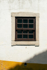 Brown wooden window frame in a wall