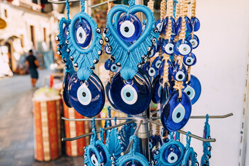 Evil eye turkish bead amulets hanging in souvenir store. Gift and superstitions concept