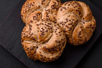 Delicious freshly baked crispy bun or kaiser roll with sesame seeds