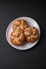 Delicious freshly baked crispy bun or kaiser roll with sesame seeds