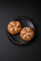 Delicious freshly baked crispy bun or kaiser roll with sesame seeds