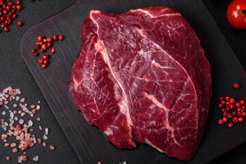 Fresh raw beef steak with salt, spices and herbs