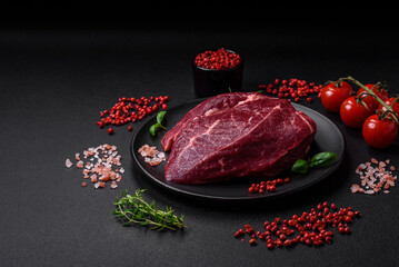 Fresh raw beef steak with salt, spices and herbs