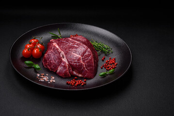 Fresh raw beef steak with salt, spices and herbs