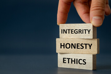 integrity honesty ethics, Ethics and honesty in life and business, hand arranging wooden blocks with the text " Integrity Honesty copy space, beautiful navy blue background