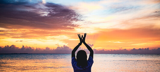 hand in lotus mudra at sunset