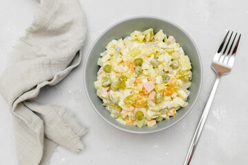 Olivier salad,Christmas food.salad with chicken and vegetables,pea.Traditional ukrainian slavic appetizer for celebrating new year's eve. Festive table setting