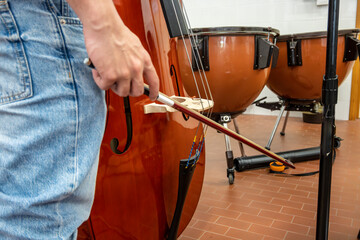 Real life young music students during rehearsals. Musical instruments and music stand with stave.