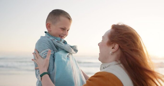 Beach, blanket and mother wrap child on a holiday or vacation to be warm and bonding feeling happy. Love, care and mom support kid on cold beach or sea for travel together enjoying quality time
