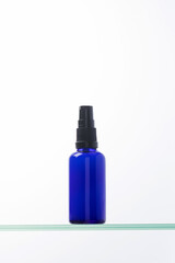 Serum for facial skin in a dropper on a glass shelf. Anti-aging cosmetics.