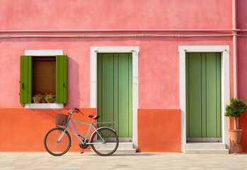 Fototapeta na wymiar A bicycle is parked next to an colorful colored house. Generative Ai