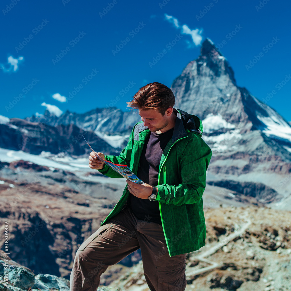 Canvas Prints Tourist with map on Matterhorn mountain background in Swiss Alps