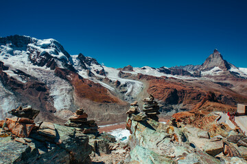 Stone pyramids in high Alps mountains with glacier