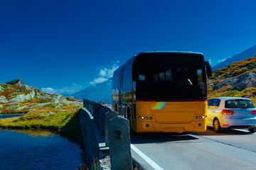 Alps road with passenger bus and car © chaossart