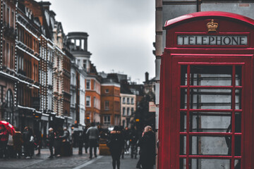 Fototapeta na wymiar Red telephone booth in the city
