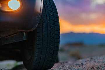 Car wheel offroad closeup view at twilight