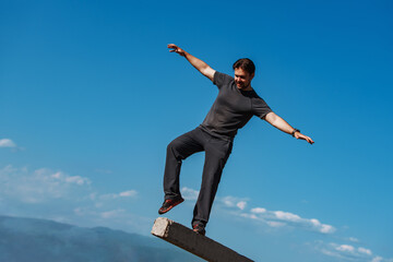 Young man balancing on mountains backgrounds