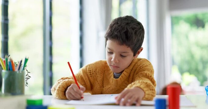 Student, drawing or boy writing homework on notebook in kindergarten education for growth development. Project, creative or young kid artist with color pencil learning or working on sketching skills