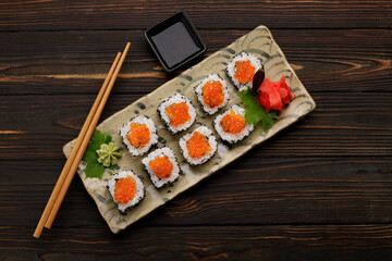 Sushi roll with red caviar, Philadelphia cheese, sesame and cucumber