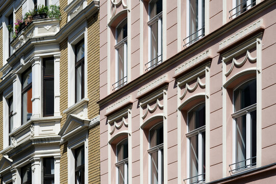 renovated facades of pastel colored and richly decorated residential houses from the end of the 19th century in cologne's eigelstein quarter