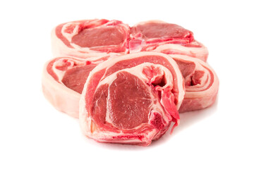 Stack of raw lamb chops on white background. Meat product of high quality and value. Food supply business.