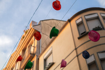 Precious street decoration with colored hats hanging in the streets. Photography made in Pontevedra, Spain