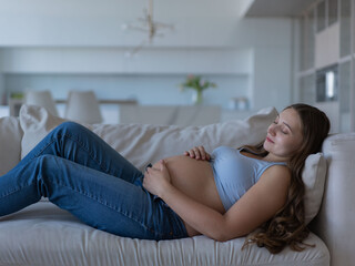 Pregnant woman lying down, head on pillow