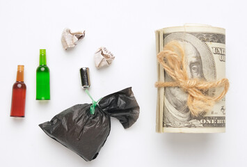 A flatlay picture of rubbish with fake cash. Rubbish dump business.