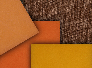 square pieces of orange, yellow and brown sponge foam on a brown fiberboard surface. absorbent and...